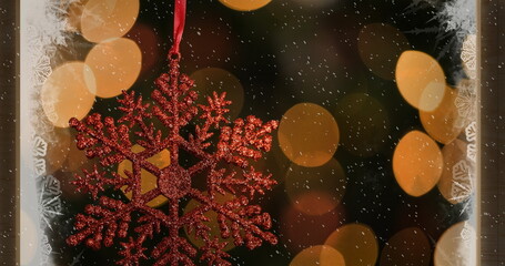 Image of red christmas decoration with snow falling and lights