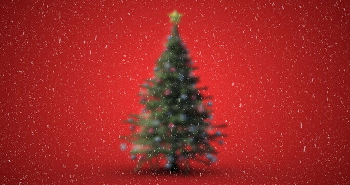Image of christmas tree with snow falling on red background