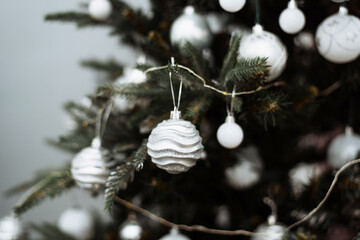 Christmas tree branch decorated with silver balls and white garland