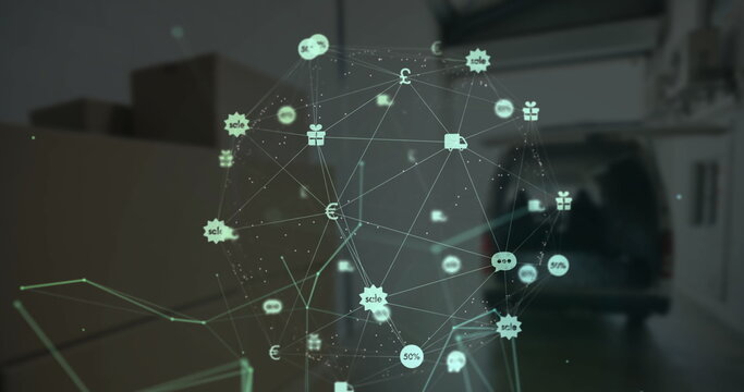 Globe of digital icons against cardboard boxes in garage - Powered by Adobe