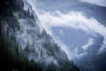 A rainy day in the Austrian Alps with deep clouds and fog - travel photography