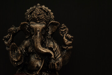 Souvenir figurine of the Indian god Ganesha on a black background