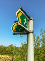 Signpost on a country walk showing the way to a footpath for pedestrians