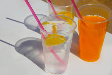 water with lemon on the background of sand
