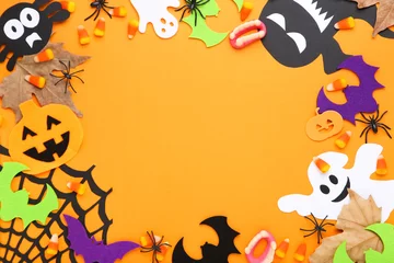 Fotobehang Halloween candies with paper pumpkins, ghosts, bats and maple leafs on orange background © 5second