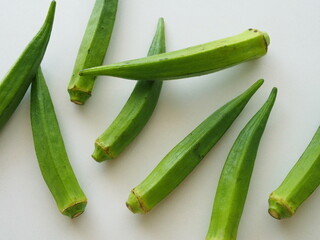 白いテーブルにランダムに置かれたオクラ