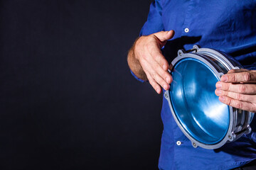 Closeup drummer male hands with drum. Man is drumming on metallic blue percussion musical...