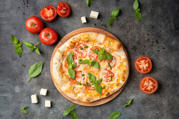 Pizza Margherita on gray stone background, top view. Pizza Margarita with Tomatoes, Basil and Mozzarella Cheese close up.