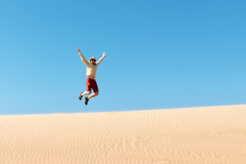 Single man throws sand in the Namib desert