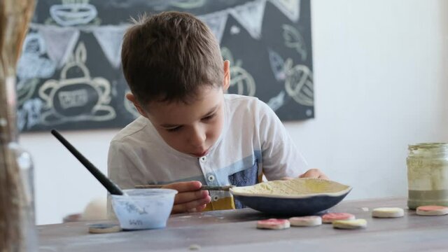 workshop for kids. Children learning how to use clay for making beautiful dishes. Workshop, master class.