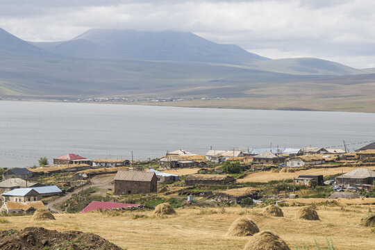 View of village houses and a farm on the shores of Lake Paravani, in Javakheti, Georgia