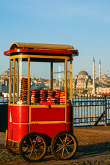 Cart with Turkish bagels known as Simit with the skyline of Istanbul, Turkey