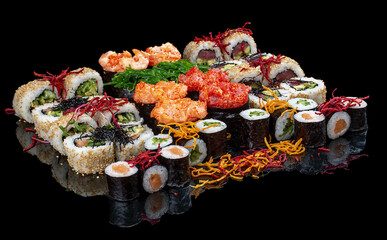 A set of assorted large sushi rolls on a glossy black background