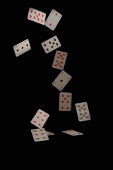 Fototapeta na wymiar Flying playing cards on a black background.