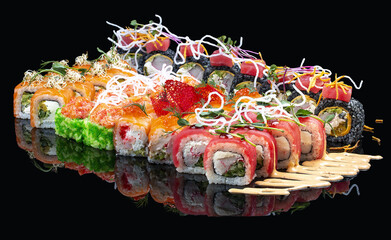 A set of assorted large sushi rolls on a glossy black background