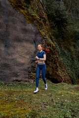 Naklejka na ściany i meble Running slim woman.Redhead Female Runner Jogging during Outdoor Workout in Park. Beautiful fit adult female in sportswear. Fitness model outdoors. Weight Loss. Healthy lifestyle. Morning
