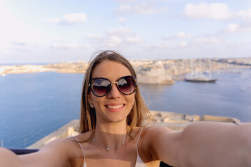 personal perspective of a woman taking a selfie in a panoramic spot in La Valletta, Malta