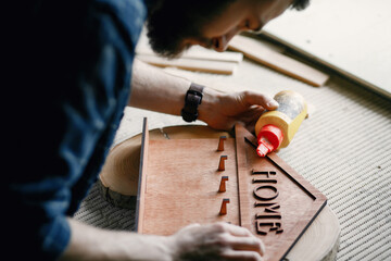 Woodworker applying glue to coards