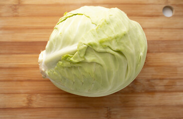 head of cabbage on a wooden board. Proper nutrition, weight loss, fresh vegetables from the garden. Cabbage swing on the board