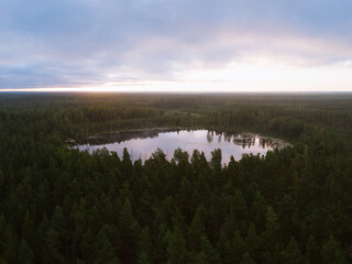 Fototapeta premium Lake in the woods with a clouds in the sky shot at the sunrise