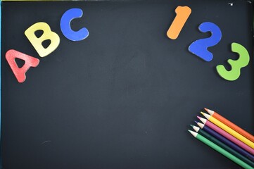 Black chalkboard with ABC and 123 back to school concept