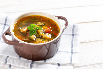 Soup with lentils and vegetables on a light table. Place for text