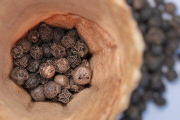 black pepper grains on a white background