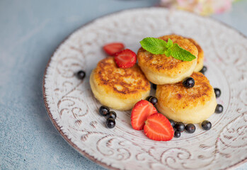 cheese pancake for breakfast with berries in a restaurant