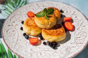cheese pancake for breakfast with berries in a restaurant