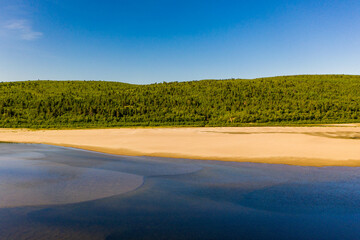 Aerial view of river Karasjohka, sandy beach and forest at the border of Finland and Norway
