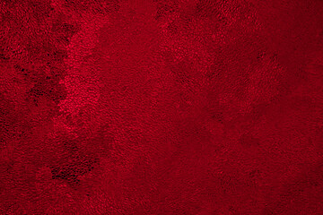 Deep red winter background or wallpaper. Rich saturated bright color. Tinted grainy backdrop in...