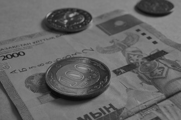 Kazakh money. A bill in 2000 tenge, a coin in 100 tenge and others. A coin of the sample of 2019 with inscriptions in Latin. Dark gray background or wallpaper. Economy and banking. Close up