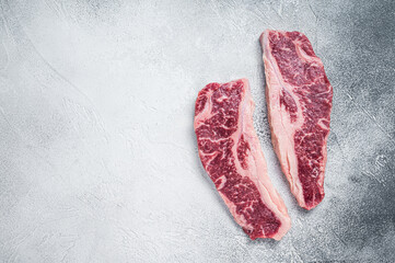 Striploin steak or New York steak, raw beef butchery meat cut. White background. Top view. Copy space