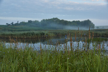 Obraz na płótnie Canvas Sunrise over the lake. Fishing on the lake. Recreation center. August 2021.