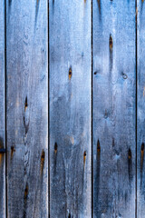 Old blue scratched wooden background with pieces of old paint and screws nails. Rustic obsolete boards of wall, door or floor. Selective focus