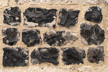 Close up of an old brick wall in Honfleur, France, for an abstract background texture.