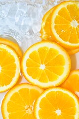 Fototapeta na wymiar Close-up fresh slices of juicy orange on white background. Slices of orange in sparkling water on white background, closeup. Citrus soda. Copy space