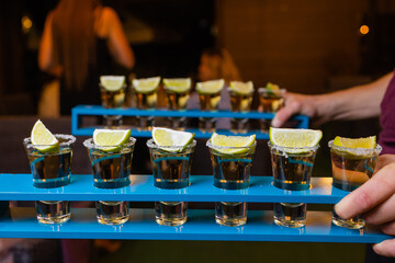 Barman make alcoholic shots with rum and liquor.