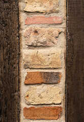 Close up of combined old wooden and brick wall in Honfleur, France, for an abstract background texture.