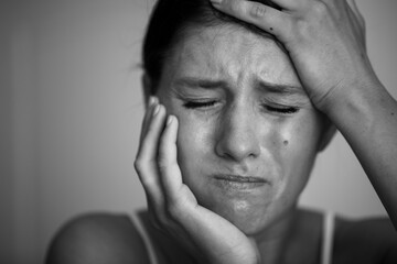 A businesswoman with a headache holding head