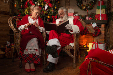 Santa Claus and wife Mrs. Claus near fireplace © TSViPhoto