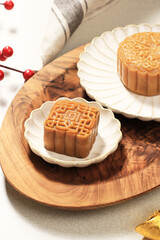 Obraz na płótnie Canvas Square Shape Moon Cake (Mooncake) Chinese Dessert Snack during Lunar New Year Mid Autumn Festival. Concept White Asian Bakery