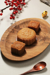 Mooncake on Light Background with Tea. Concept Moon Cake on Mid Autumn Festival or Chinese New year (Imlek). Mooncake Popular as Kue Bulan. Served with Chinese Tea