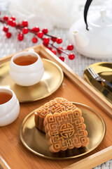Square Shape Moon Cake (Mooncake) Chinese Dessert Snack during Lunar New Year Mid Autumn Festival. Concept White Asian Bakery, Served with Tea