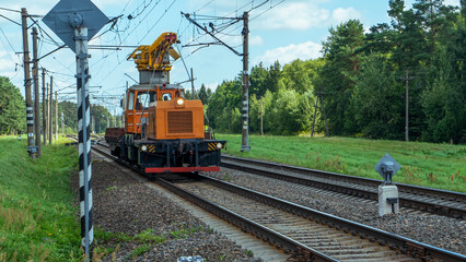 Special train with a landing crane for service and repair of electrical networks on the railway. Heavy machinery repairs rail lines. Railroad concept.