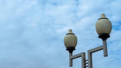 Street lights against a blue sky at day. Space for text. Background for design.