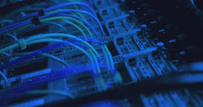 Close-up view of modern internet network switch with plugged ethernet cables. Blinking green lights on internet server. Optical server. Commutator. Flashing lights. Optical fiber. Video IP Gateways.