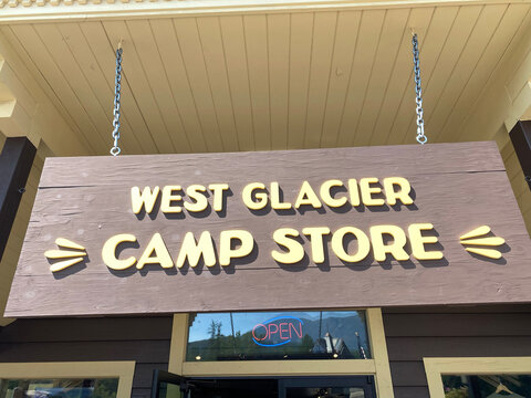 West Glacier, Montana - August 13, 2021: Sign For The West Glacier Camp Store, A Shop Selling Camping Gear And Sporting Goods For Tourists In Glacier National Park