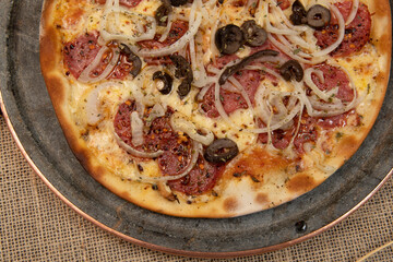 Brazilian pizza with pepperoni, cheese, onion and black olive
