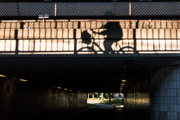 Stockholm, Sweden Aug 20, 2021 The shadow of a bicyclist on a wall of an underpass at Gullmarsplan.